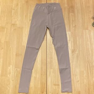 Gymshark tan leggings with laser cut holes.